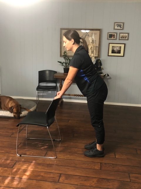Demonstrating the starting position of the chair press walkout