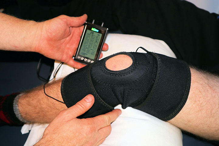 A tens unit on a patient with a knee injury.
