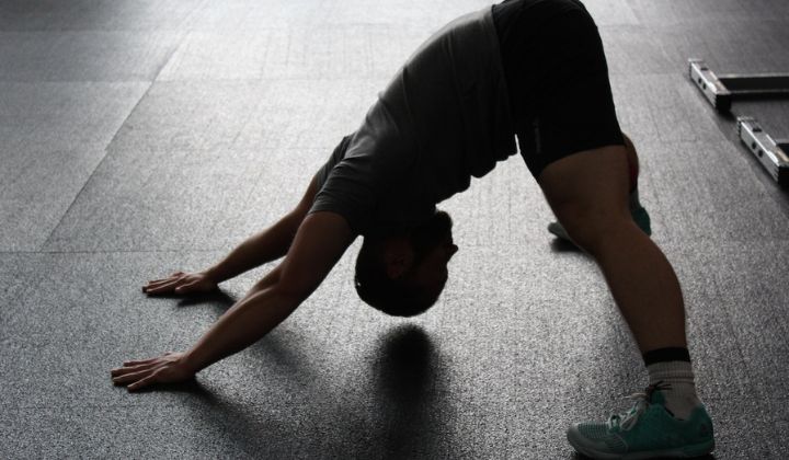 A man working on his posterior chain flexibility with a stretch.