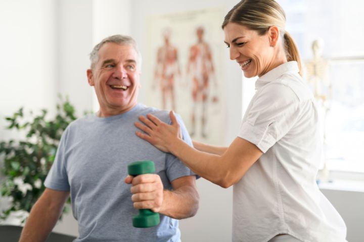 A physical therapist working with a patient in her clinic.